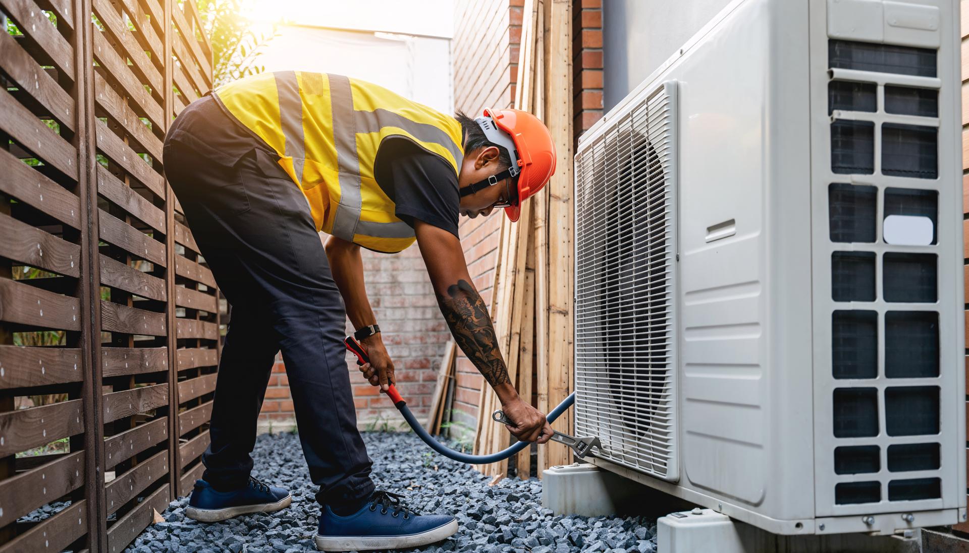 HVAC Technician Installing Air Conditioner Outdoor Unit Professional Service and Maintenance
